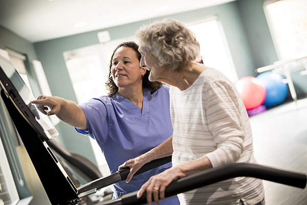 Nurse with woman on balance machine