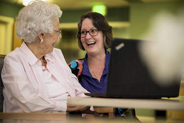 Woman and nurse laughing